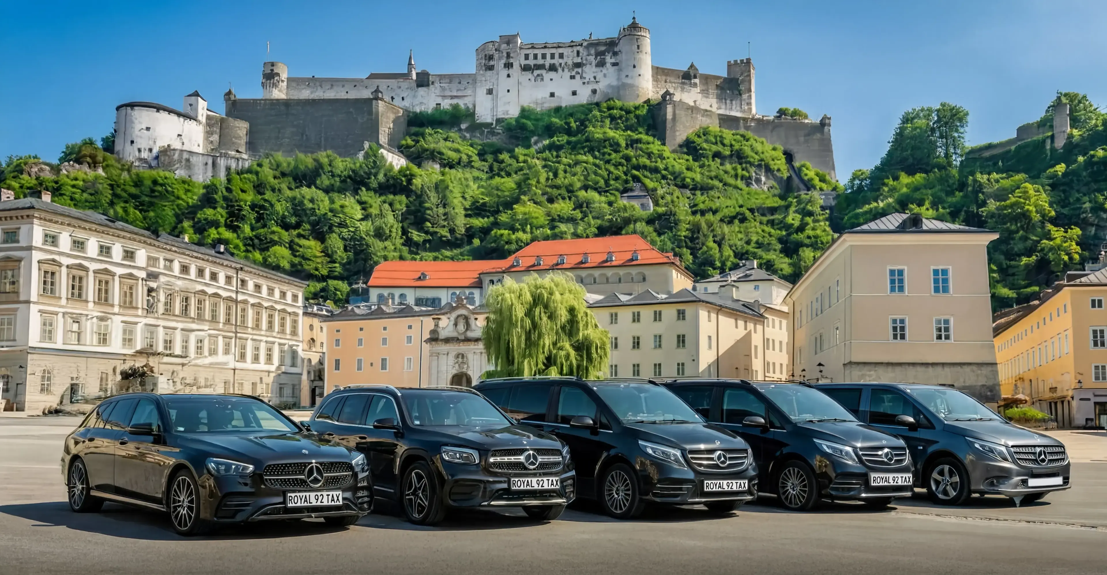 Salzburg Taxi Mercedes fleet below Hohensalzburg Fortress in Salzburg's historic centre